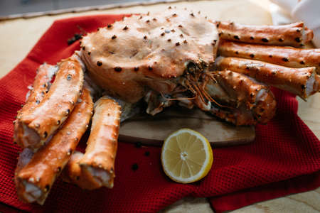 crab lemon on a red tablecloth on a wooden tableの写真素材