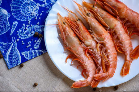 spiny lobster on a white plate on a gray tableclothの写真素材