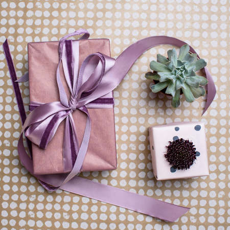 Two pink gift box with scabiosa flower and succulent on craft paperの写真素材