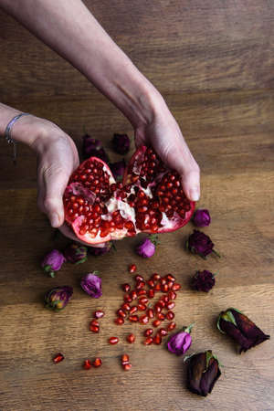 Ripe pomegranate fruit on wooden vintage background.の写真素材