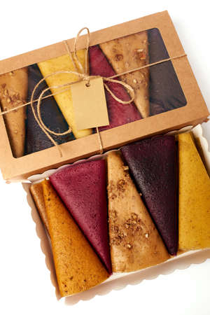 Mix fruit pastille marshmallow close-up in craft paper rectangular box with transparent lid on white background. Vegetarian lifestyle.の写真素材