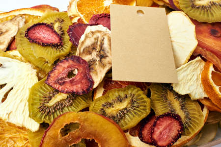 Close-up mix dried fruits with craft paper card. Vegetarian lifestyle.の写真素材