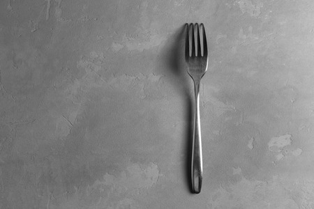 Shabby fork on the gray concrete backgroundの写真素材
