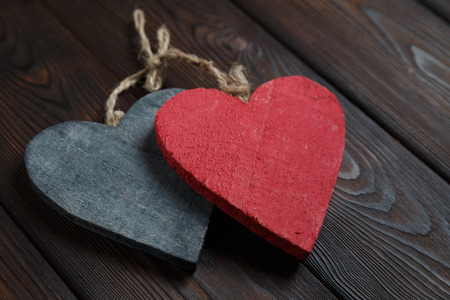 Handmade wooden hearts on dark old wood backgroundの写真素材