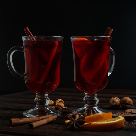 Mulled wine with delicious orange and spic on the dark old wood backgroundの写真素材