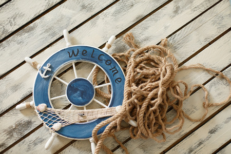 Steering wheel on old wood background. Skipper's wheel from an old ship.の写真素材