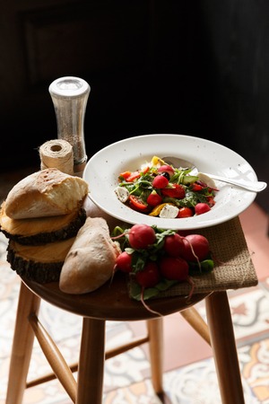 Fresh salad in the plate, redish, breadの写真素材