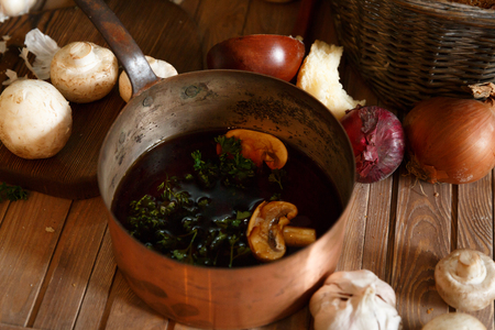 Still life from a pot of mushroom soup and ingredientsの写真素材