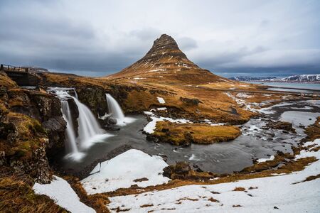 Famous mountain with waterfalls in Iceland, kirkjufell, winter in Iceland, ice and snow,...