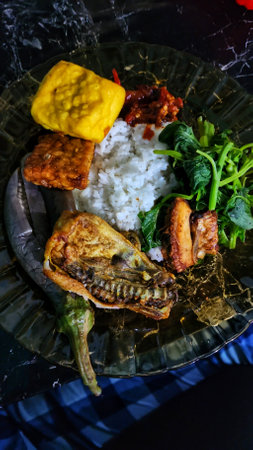 Fried fish with rice and vegetables on the table,Indonesiaの写真素材