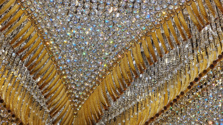 Gold sequins on the fabric as a background. Close-up