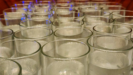 Glasses with water and ice on a table at a wedding receptionの写真素材