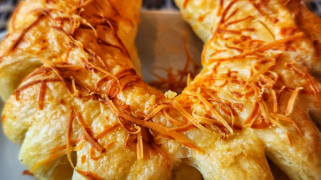 Crispy puff pastry with cheese and caramelized onion, closeupの写真素材