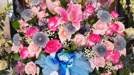 Bridal bouquet of pink and white flowers with blue bowsの写真素材