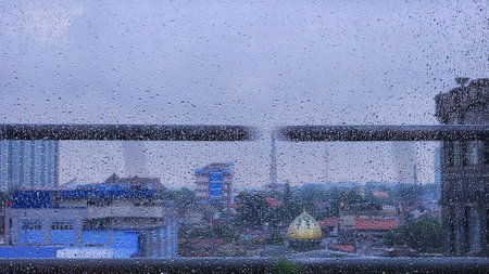 Raindrops on the window with city view, Bangkok, Thailand.