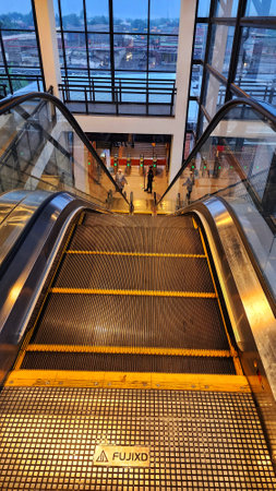 an escalator in an airport with people walking on it