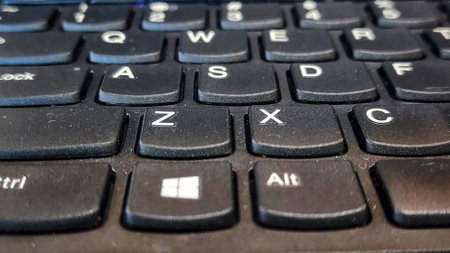 Close up of black keyboard of a modern laptop with shallow depth of field