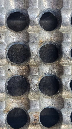 A close up shot of a metal panel with holes in it.の写真素材