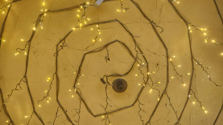 Christmas lights on the wall of the house in the form of a spiral