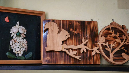 Wooden carved figures of animals and birds on a shelf in a restaurantの写真素材