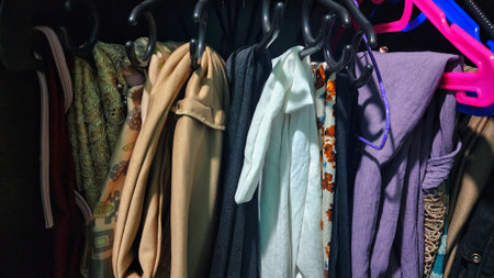 Clothes on hangers in a store, closeup of photoの写真素材