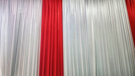 Close up of a red and white curtain on a stage in a theaterの写真素材