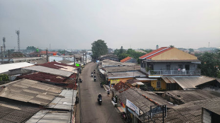 Bogor, Indonesia. 22 May 2025. An Indonesian street scene with motorcycles traveling down a road.の写真素材