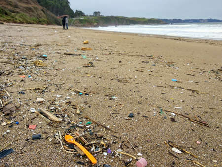 Microplastic pollution in the beach. Arenal de Moris beach, Colunga, Asturias, Spain