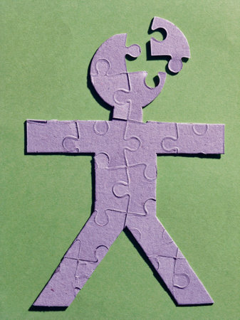 Silhouette of a human made with puzzle pieces simulating some mental problemの写真素材