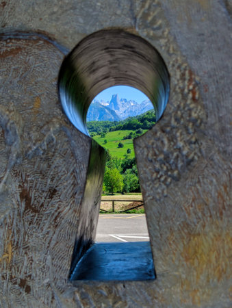 Silhouette of the Naranjo de Bulnes peak seen through a keyhole sculpture at Pozo de la Oracion viewpoint, Poo de Cabrales, Asturias, Spainの写真素材