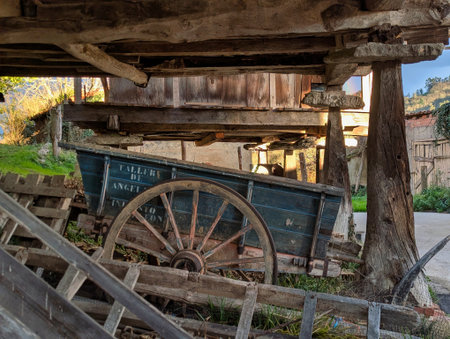 Detail of various tools such as a cart under a typical centenary Asturian granary called horreo in the village of Candones, Cabranes municipality, Asturias, Spainの写真素材