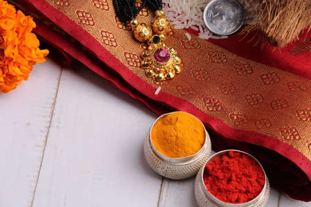 oti bharne - Indian ritual of offering a sari and a blouse piece along with coconut, haldi kumkum, bangles, mangalsutra and rice. At the time of navratri to goddes or married woman.の写真素材