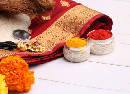 oti bharne - Indian ritual of offering a sari and a blouse piece along with coconut, haldi kumkum, bangles, mangalsutra and rice. At the time of navratri to goddes or married woman.の写真素材