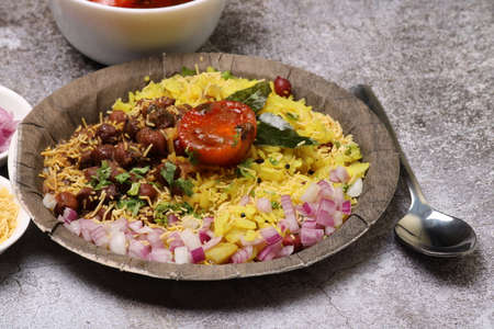 Aloo/Kanda Poha or Tarri Pohe with spicy chana masala/curry. Served in ceramic plate.の写真素材