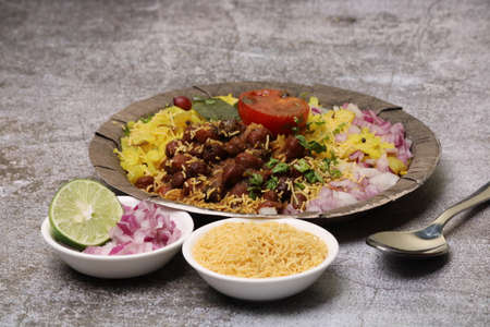 Aloo/Kanda Poha or Tarri Pohe with spicy chana masala/curry. Served in ceramic plate.の写真素材