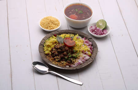 Aloo/Kanda Poha or Tarri Pohe with spicy chana masala/curry. Served in ceramic plate.の写真素材