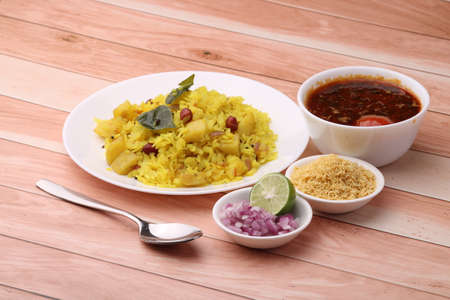 Aloo/Kanda Poha or Tarri Pohe with spicy chana masala/curry. Served in ceramic plate.の写真素材