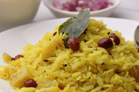 Aloo/Kanda Poha or Tarri Pohe with spicy chana masala/curry. Served in ceramic plate.の写真素材