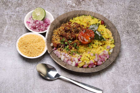 Aloo/Kanda Poha or Tarri Pohe with spicy chana masala/curry. Served in ceramic plate.の写真素材