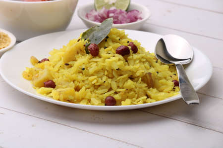 Aloo/Kanda Poha or Tarri Pohe with spicy chana masala/curry. Served in ceramic plate.の写真素材