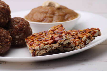 Navratri Upwas sweets food platter dry fruit laddu, groundnut chikki or toffee and sheera.の写真素材