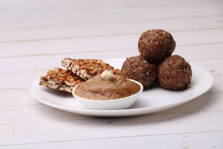 Navratri Upwas sweets food platter dry fruit laddu, groundnut chikki or toffee and sheera.の写真素材