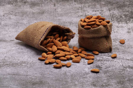 Almonds in bag isolated on grey backgroundの写真素材