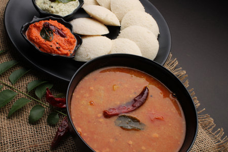 Idly sambar or Idli with Sambhar and green, red chutney. Popular South indian breakfast
