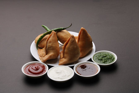 Kachori and samosa, Indian vegetarian snacks served with  green and tamarind chutneys.