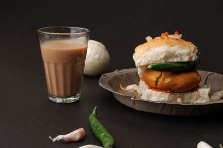 Masala cutting chai and Bombay vada paav is an indian burger. Potato patty is deep fried in gram flour or besan batter it is served hot with paav or bun like sandwich.の素材 [FY310163141415]