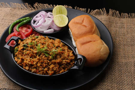 Masala Anda Bhurji or Spicy Indian scrambled eggs with bread or Bun Pav, Popular street foodの写真素材