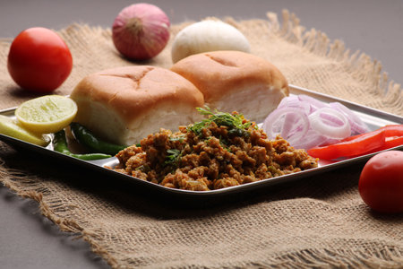 Masala Anda Bhurji or Spicy Indian scrambled eggs with bread or Bun Pav, Popular street food