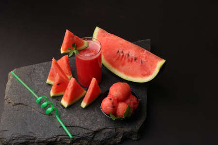 Watermelon smoothies or juice topping with fresh watermelon and mint leaves for summer drinks conceptの写真素材