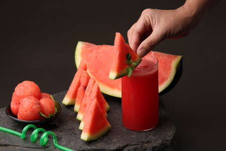 Watermelon smoothies or juice topping with fresh watermelon and mint leaves for summer drinks...